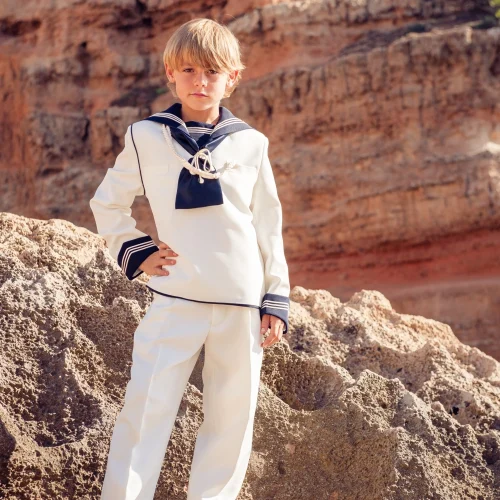 kid-in-marine-outfit-standing-on-rocky-cliff-2025-01-06-18-10-26-utc